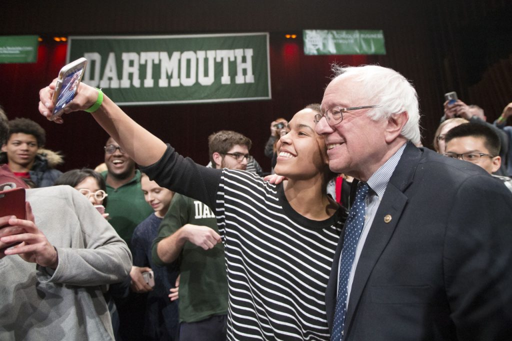 Democratic presidential candidate, Sen. Bernie Sanders, I-Vt, right, has a selfie taken with an audience member after speaking at a campaign stop at Dartmouth College, Thursday, Jan. 14, 2016, in Hanover, N.H. (AP Photo/John Minchillo)